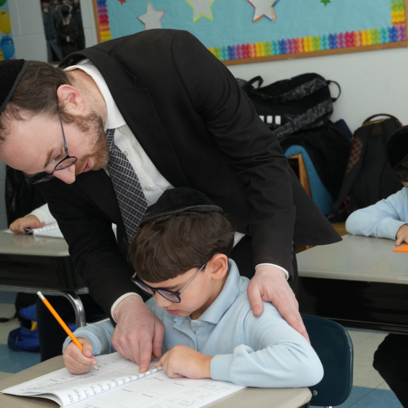 rabbi with student teaching him to write